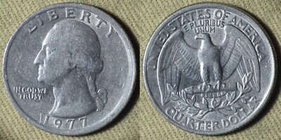 1977 quarter broadstrike error showing wider diameter and smooth rim compared to a normal reeded-edge quarter